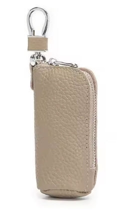 Beige key pouch with a metal keychain on a white background
