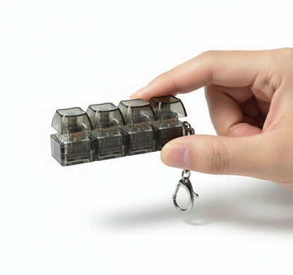 Black keychain light with clear cube lights on a white background