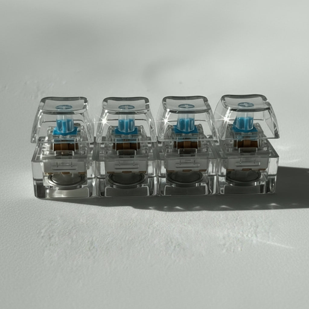 Close-up of transparent keyboard switches on a gray surface